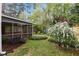 A screened-in porch steps onto the lush backyard landscaping at 1205 Country Ridge Dr, Raleigh, NC 27609
