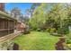Grassy backyard showcasing a screened-in porch and landscaped yard at 1205 Country Ridge Dr, Raleigh, NC 27609