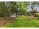 Large backyard with shed surrounded by mature trees at 1205 Country Ridge Dr, Raleigh, NC 27609