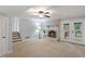Finished basement with a cozy fireplace, neutral carpet, and access to stairs and an exterior patio at 1205 Country Ridge Dr, Raleigh, NC 27609