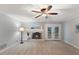 Cozy basement featuring a white brick fireplace, carpet flooring, and ceiling fan at 1205 Country Ridge Dr, Raleigh, NC 27609
