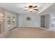 Carpeted basement space with a ceiling fan, fireplace, and sliding glass doors to the exterior at 1205 Country Ridge Dr, Raleigh, NC 27609