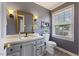 Bathroom with gray walls, single sink vanity, a window, and a toilet at 1205 Country Ridge Dr, Raleigh, NC 27609