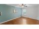 Relaxing bedroom features a ceiling fan, natural light, and hardwood floors at 1205 Country Ridge Dr, Raleigh, NC 27609
