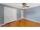 Bedroom with closet and warm hardwood floors at 1205 Country Ridge Dr, Raleigh, NC 27609