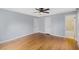 This bedroom features hardwood floors, a ceiling fan, and adjacent bathroom at 1205 Country Ridge Dr, Raleigh, NC 27609