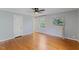 Spacious bedroom with hardwood flooring, soft gray walls, and a stylish ceiling fan at 1205 Country Ridge Dr, Raleigh, NC 27609