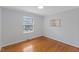 Neutral bedroom features ample light, hardwood floors, and is move-in ready at 1205 Country Ridge Dr, Raleigh, NC 27609