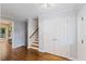 Inviting entryway with hardwood floors, staircase, and a conveniently located closet at 1205 Country Ridge Dr, Raleigh, NC 27609