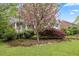 A well-manicured front yard with flowering trees and mature shrubs at 1205 Country Ridge Dr, Raleigh, NC 27609