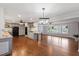 Well-appointed kitchen with island, hardwood floors, and open layout to living area at 1205 Country Ridge Dr, Raleigh, NC 27609