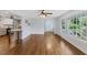 Open living space with hardwood floors, big window views, and seamless flow to kitchen at 1205 Country Ridge Dr, Raleigh, NC 27609