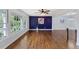 Bright and airy living room with large windows and gleaming hardwood floors at 1205 Country Ridge Dr, Raleigh, NC 27609