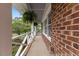 Covered porch features classic railings, brick accents, and decorative hanging plants at 1205 Country Ridge Dr, Raleigh, NC 27609