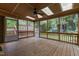 Spacious screened porch with ceiling fan and backyard views, an ideal outdoor retreat at 1205 Country Ridge Dr, Raleigh, NC 27609
