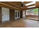 Screened porch with skylights, ceiling fan, and brick accents, perfect for relaxing or entertaining at 1205 Country Ridge Dr, Raleigh, NC 27609