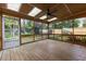 Screened-in porch with a ceiling fan and views of a well-maintained garden and landscape at 1205 Country Ridge Dr, Raleigh, NC 27609