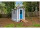 Outdoor shed with a blue door and white trim at 1205 Country Ridge Dr, Raleigh, NC 27609