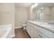 This bathroom features a double sink vanity with granite countertop, and a shower at 122 Wilderness Trl, Smithfield, NC 27577