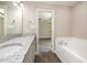 This bathroom features a double sink vanity with granite countertop and a soaking tub at 122 Wilderness Trl, Smithfield, NC 27577
