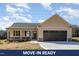 Charming single-story home featuring a two-car garage, covered porch, and neutral-tone siding at 122 Wilderness Trl, Smithfield, NC 27577