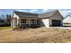 Inviting single-story home with a covered front porch and a well-maintained lawn at 122 Wilderness Trl, Smithfield, NC 27577