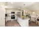 This staged kitchen features stainless steel appliances, granite countertops, and a kitchen island with barstool seating at 122 Wilderness Trl, Smithfield, NC 27577