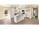 Bright kitchen featuring white cabinets, granite countertops, an island, and stainless steel appliances at 122 Wilderness Trl, Smithfield, NC 27577