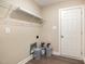 The laundry room includes a wire rack and storage for laundry supplies at 122 Wilderness Trl, Smithfield, NC 27577