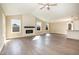 Spacious living room with vaulted ceiling, fireplace, and large windows providing natural light at 122 Wilderness Trl, Smithfield, NC 27577