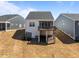 Exterior rear of home featuring a raised deck, sliding glass door, and basement entrance at 1241 White Flint Cir, Durham, NC 27703
