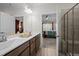 Bright bathroom with double vanity, wood cabinets, and tiled shower with glass door at 1241 White Flint Cir, Durham, NC 27703