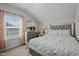 Comfortable bedroom featuring a large window, floral bedding, and mirrored night stand at 1241 White Flint Cir, Durham, NC 27703