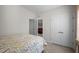Bright and airy bedroom with neutral walls, floral bedding and closet doors at 1241 White Flint Cir, Durham, NC 27703