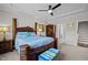 Beautiful bedroom with tray ceilings, dark wood furniture, and a fan at 1241 White Flint Cir, Durham, NC 27703