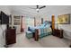 Well-lit bedroom with dark furniture, ceiling fan, and window views at 1241 White Flint Cir, Durham, NC 27703