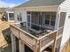 View of outdoor deck with patio table and seating, enclosed with screened walls at 1241 White Flint Cir, Durham, NC 27703