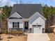 Charming single-Gathering home showcasing stone accents, a front-entry garage, and inviting curb appeal at 1241 White Flint Cir, Durham, NC 27703