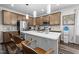Modern kitchen featuring stainless appliances, a tile backsplash, sleek cabinets, and a large island with sink at 1241 White Flint Cir, Durham, NC 27703