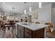 Bright kitchen island featuring pendant lights, ample storage, and an integrated sink at 1241 White Flint Cir, Durham, NC 27703
