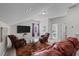 Cozy living room with comfortable seating, large television and plenty of natural light at 1241 White Flint Cir, Durham, NC 27703