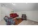 Comfortable living area with a leather sofa, patterned chairs and a glass coffee table at 1241 White Flint Cir, Durham, NC 27703
