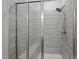 Modern bathroom featuring a tiled shower with glass doors and a built-in bench at 1241 White Flint Cir, Durham, NC 27703
