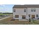 Exterior of home features patio space, sliding glass doors, and level backyard at 125 Paperwhite Pl, Clayton, NC 27527