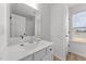 Bathroom with a white vanity, undermount sink, and framed mirror at 125 Paperwhite Pl, Clayton, NC 27527