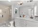 Well-lit bathroom featuring a double sink vanity, shower with glass door, and modern fixtures at 125 Paperwhite Pl, Clayton, NC 27527