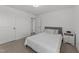 Bedroom featuring neutral carpet, white trim, and a bed with a gray headboard at 125 Paperwhite Pl, Clayton, NC 27527