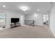 Bonus room with carpet, a television, and stairs leading to the downstairs area at 125 Paperwhite Pl, Clayton, NC 27527