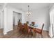 Dining room with a glass table, seating for six, and contemporary lighting fixture at 125 Paperwhite Pl, Clayton, NC 27527