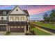 Charming two-story home with a brick facade and an attached two-car garage at 125 Paperwhite Pl, Clayton, NC 27527